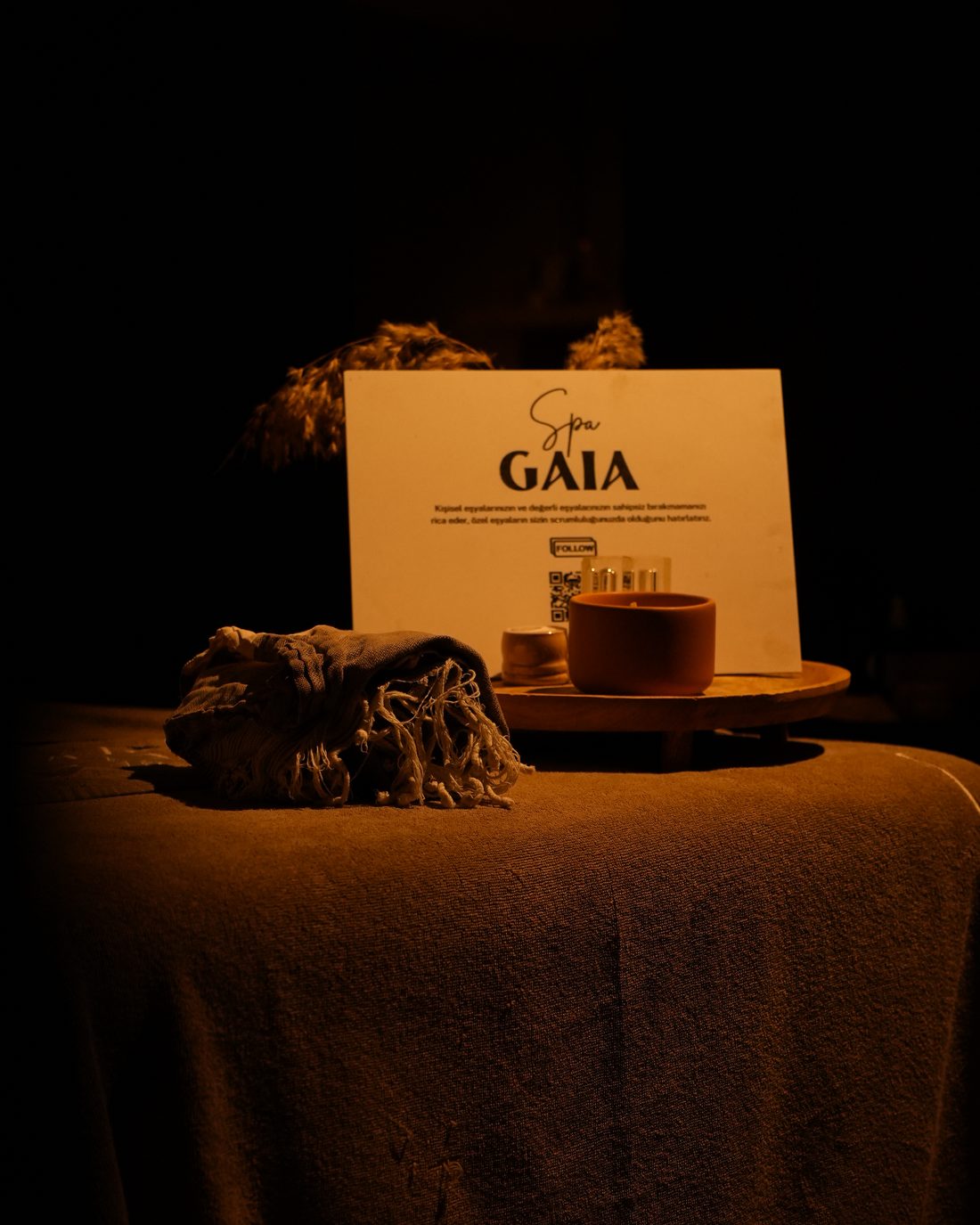 A Spa Gaia table set with a candle, the menu card and folded cloth